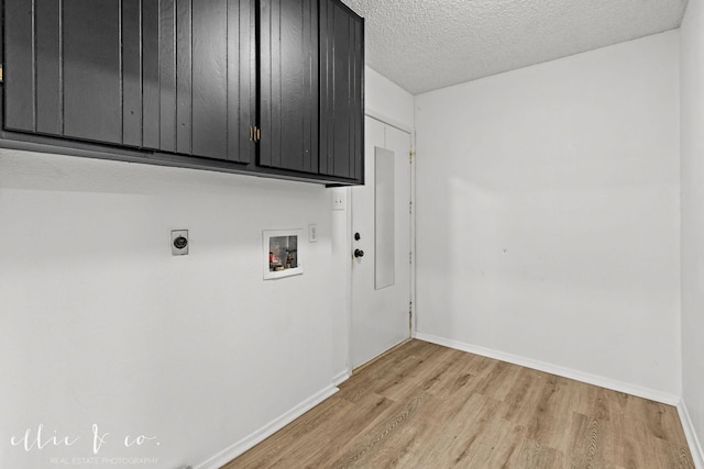 laundry room with a textured ceiling, cabinets, light hardwood / wood-style floors, hookup for a washing machine, and hookup for an electric dryer