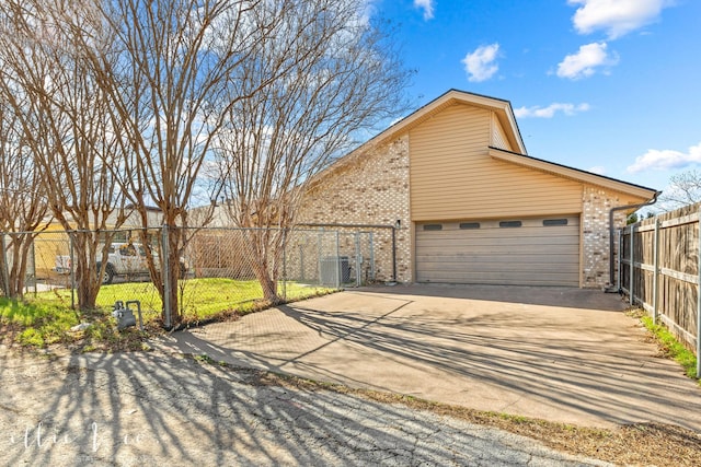 view of front of home featuring central AC and a garage