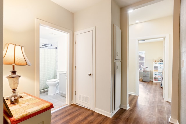 hall with wood-type flooring