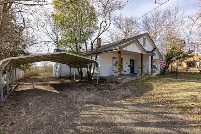 view of front of home featuring covered porch and a carport