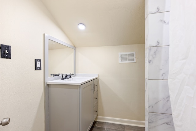 bathroom with vanity and vaulted ceiling