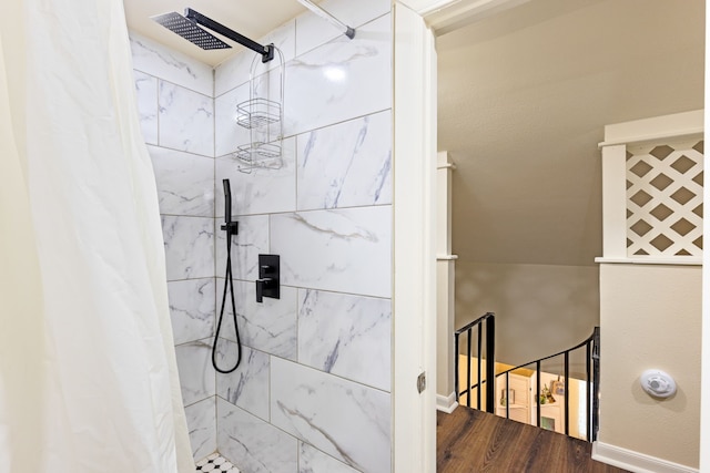 bathroom featuring walk in shower and hardwood / wood-style floors