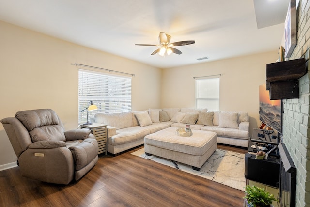 living room featuring hardwood / wood-style floors, a fireplace, and ceiling fan