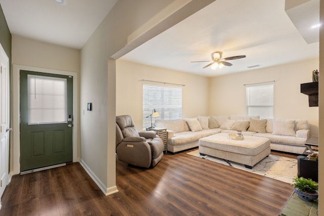 living room with ceiling fan and dark hardwood / wood-style floors