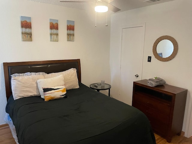 bedroom with ceiling fan and light hardwood / wood-style floors