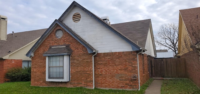 view of side of home with a yard