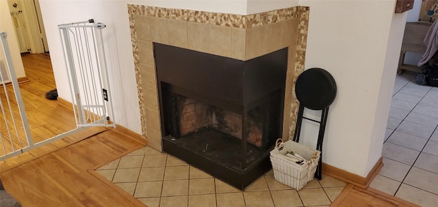 room details with wood-type flooring and a tiled fireplace