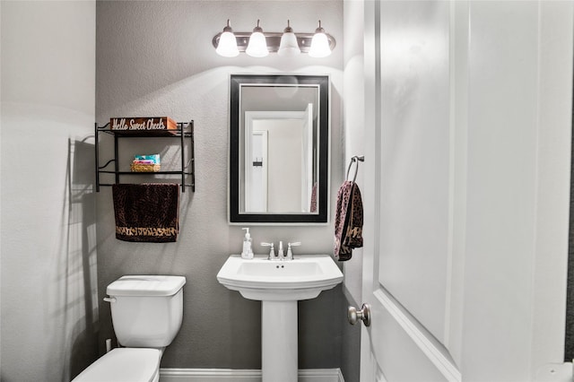 bathroom with toilet and sink