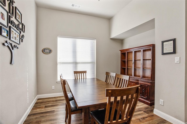 dining space featuring dark hardwood / wood-style flooring