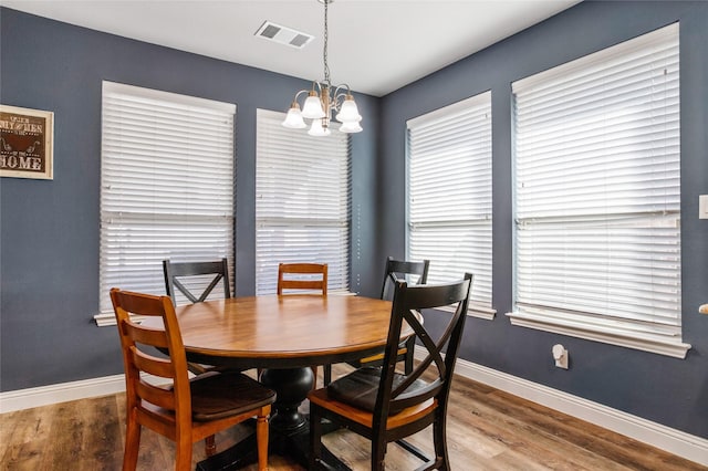 dining room featuring a notable chandelier and hardwood / wood-style floors