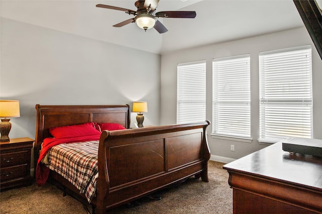 carpeted bedroom with ceiling fan and vaulted ceiling