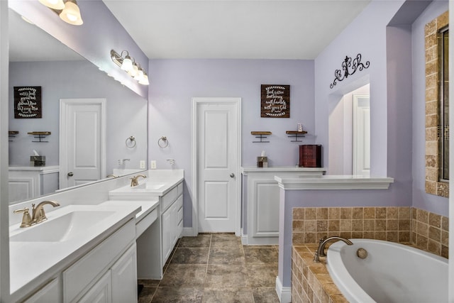 bathroom with tiled bath and vanity