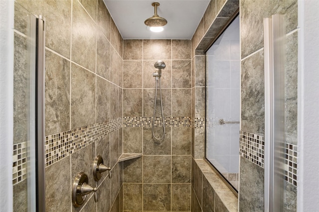 bathroom with a tile shower