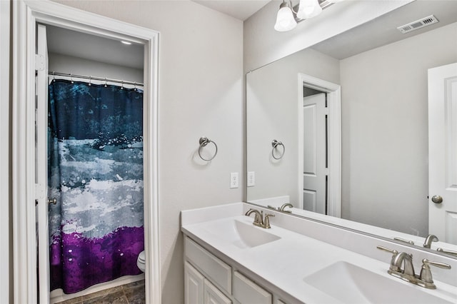 bathroom featuring toilet and vanity