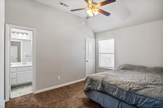 bedroom featuring sink, carpet flooring, vaulted ceiling, ceiling fan, and ensuite bath