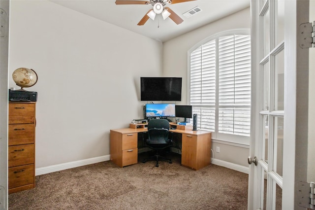 carpeted office featuring ceiling fan