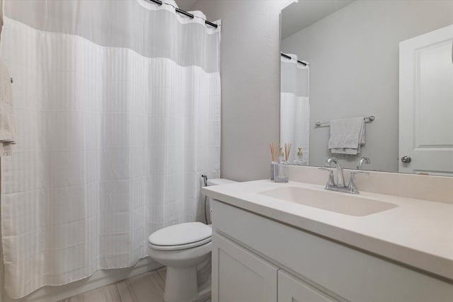 bathroom with toilet, vanity, and a shower with shower curtain