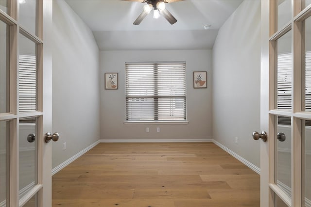 unfurnished room with ceiling fan, light hardwood / wood-style floors, lofted ceiling, and french doors