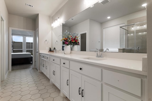 bathroom with tile patterned flooring, vanity, and a shower with shower door