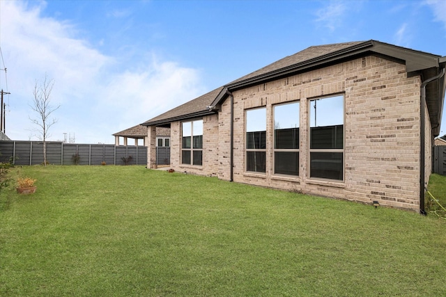 back of house with a lawn