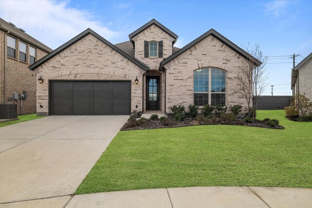 view of front of property with central AC unit, a garage, and a front lawn