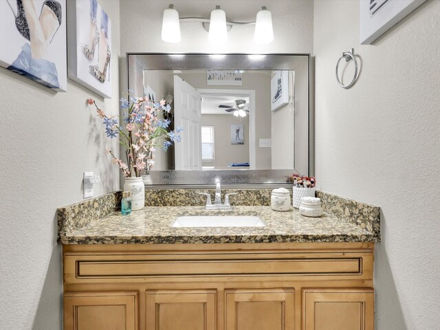 bathroom featuring vanity, a shower with door, and ceiling fan