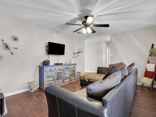 dining room with ceiling fan with notable chandelier and dark hardwood / wood-style floors