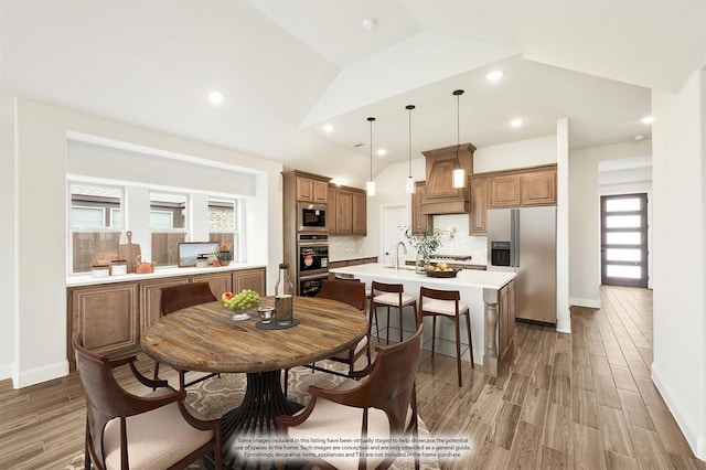 dining space featuring lofted ceiling, baseboards, recessed lighting, and light wood-style floors