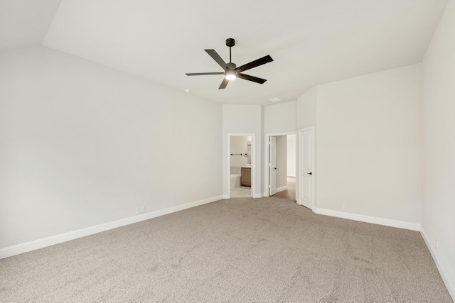 unfurnished bedroom with baseboards, vaulted ceiling, and carpet