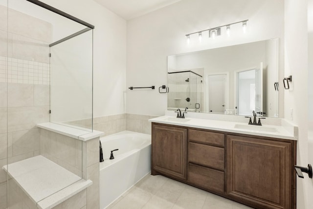 full bathroom featuring a bath, a sink, double vanity, and a stall shower