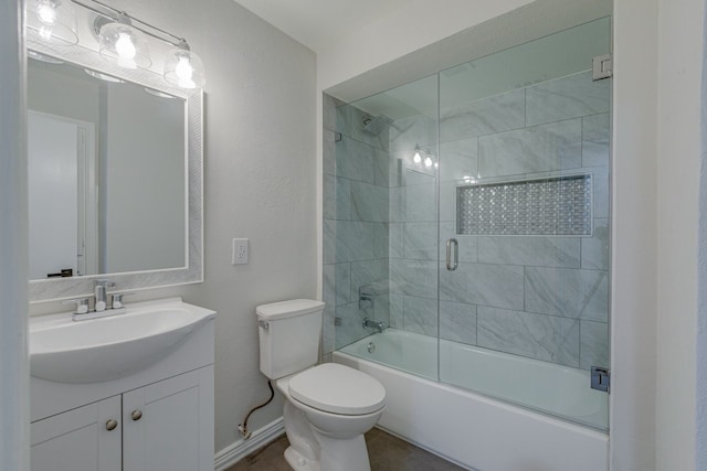 full bathroom with toilet, vanity, and combined bath / shower with glass door