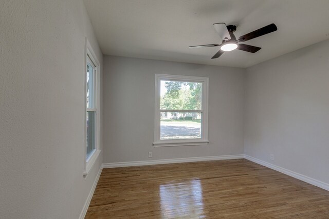 spare room featuring hardwood / wood-style flooring and ceiling fan