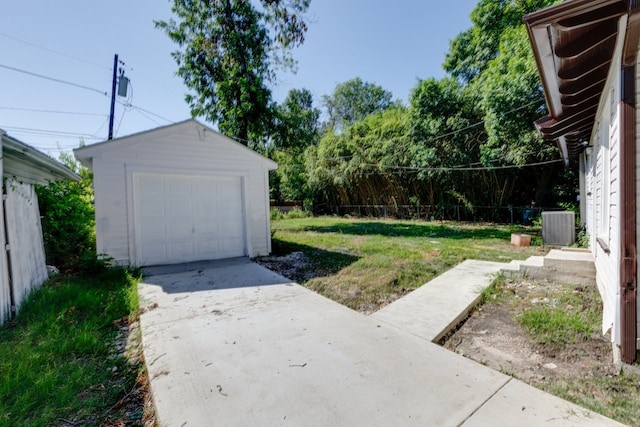 view of yard with a garage and an outbuilding