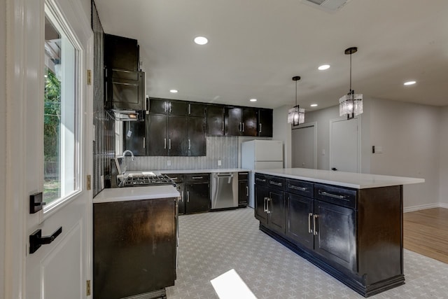 kitchen featuring dark brown cabinetry, a center island, hanging light fixtures, stainless steel dishwasher, and white fridge