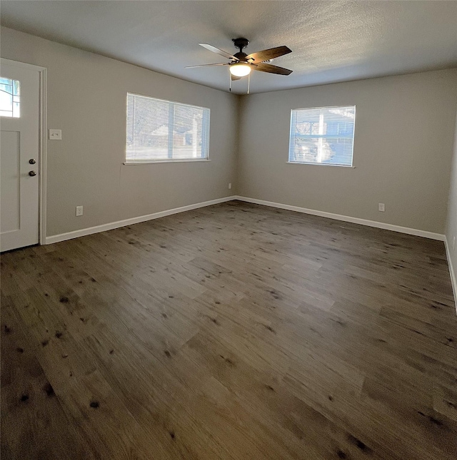 foyer with a textured ceiling, dark hardwood / wood-style floors, and ceiling fan