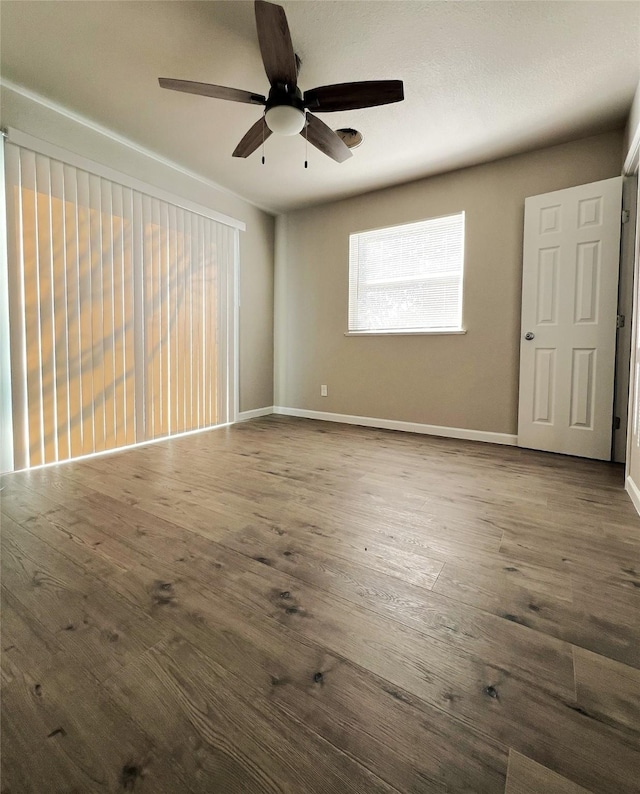 unfurnished room with hardwood / wood-style floors and ceiling fan