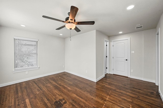 spare room with ceiling fan and dark hardwood / wood-style flooring