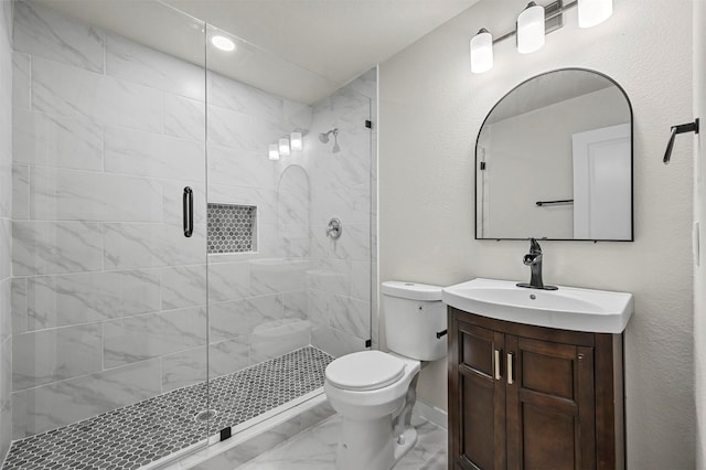 bathroom with vanity, toilet, and an enclosed shower