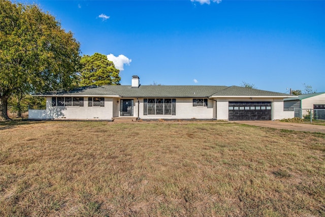 ranch-style home featuring a garage and a front yard