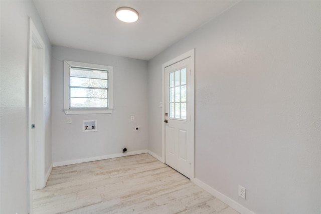 clothes washing area with washer hookup, light hardwood / wood-style floors, and electric dryer hookup