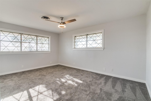 spare room with carpet, ceiling fan, and a wealth of natural light