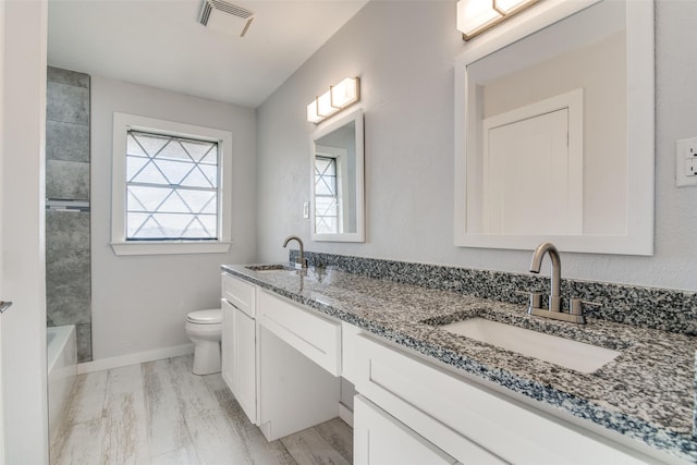 bathroom featuring hardwood / wood-style floors, vanity, and toilet