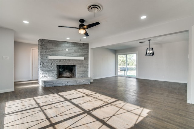 unfurnished living room featuring ceiling fan, a fireplace, and dark wood-type flooring