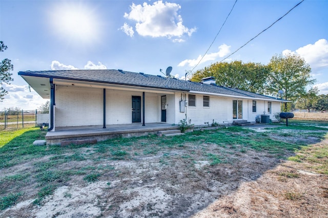 back of property with a patio area, a yard, and central AC unit