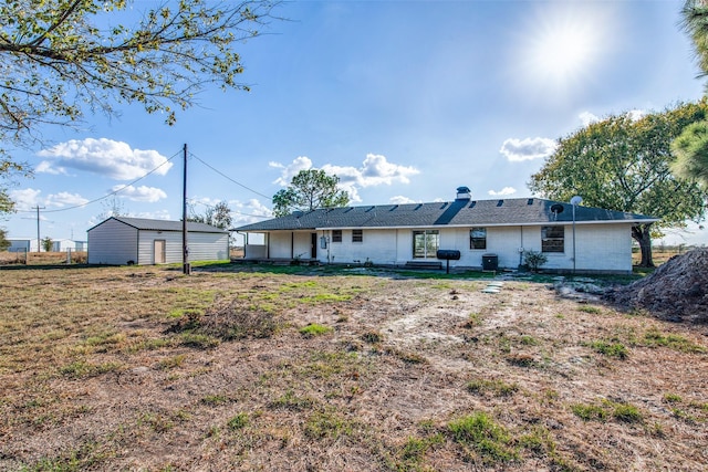 back of house with a lawn