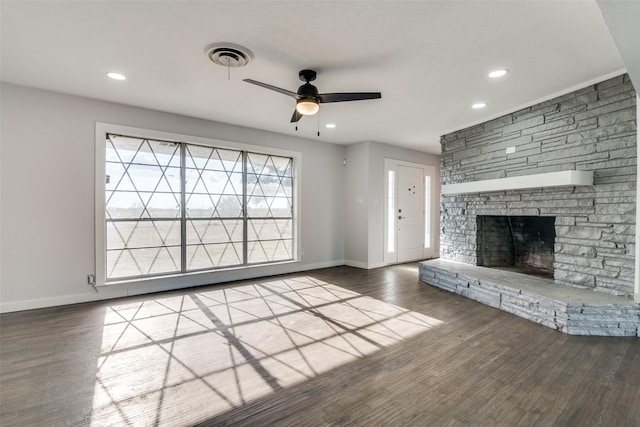 unfurnished living room featuring ceiling fan, a fireplace, and dark wood-type flooring