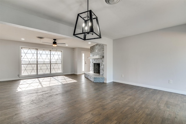 unfurnished living room with ceiling fan, wood-type flooring, and a fireplace