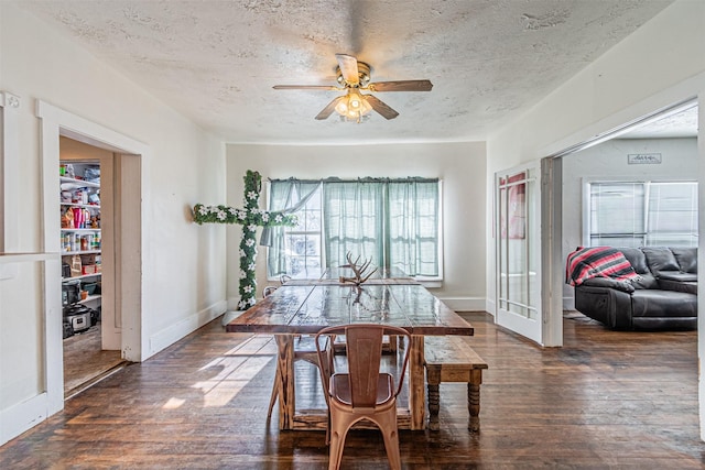 dining room with ceiling fan, dark hardwood / wood-style flooring, and a textured ceiling