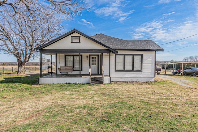 view of front of home with a porch and a front yard