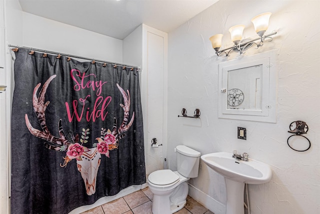 bathroom with tile patterned floors and toilet